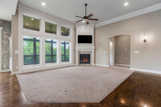 24793 W 98th St, Lenexa, KS 66227 - unfurnished living room featuring a ceiling fan, ornamental molding, arched walkways, a fireplace, and recessed lighting