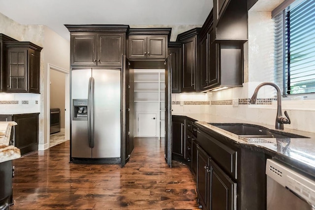 24793 W 98th St, Lenexa, KS 66227 - kitchen with appliances with stainless steel finishes, dark wood-type flooring, light stone counters, backsplash, and dark brown cabinets