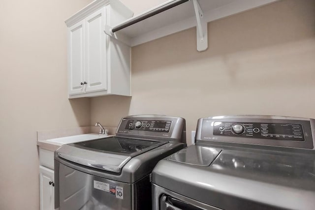 24793 W 98th St, Lenexa, KS 66227 - laundry area featuring washer and clothes dryer and cabinet space