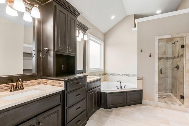 24793 W 98th St, Lenexa, KS 66227 - full bathroom with a shower stall, vaulted ceiling, a garden tub, vanity, and backsplash