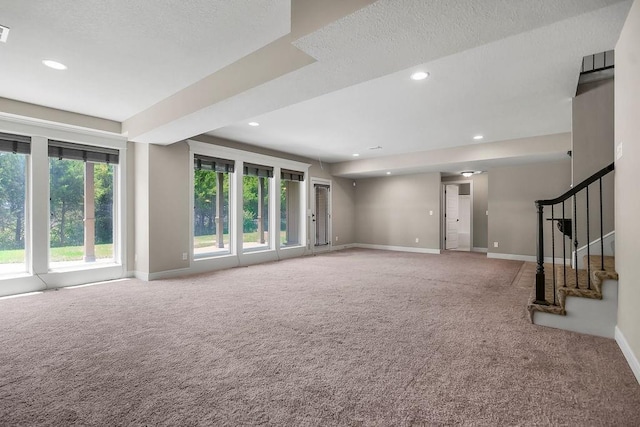 24793 W 98th St, Lenexa, KS 66227 - unfurnished living room featuring carpet, recessed lighting, stairway, and a textured ceiling