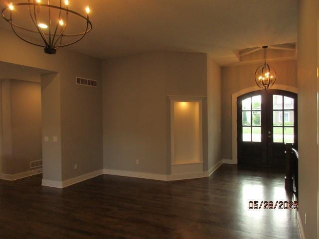 7031 N London Ave, Kansas City, MO 64151 - entryway with a chandelier, wood finished floors, baseboards, and french doors