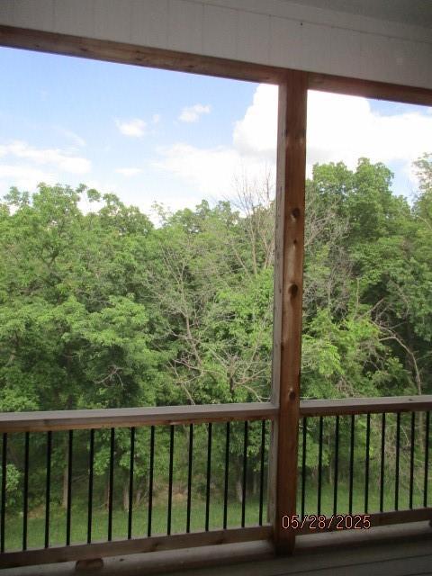 7031 N London Ave, Kansas City, MO 64151 - balcony featuring a wooded view