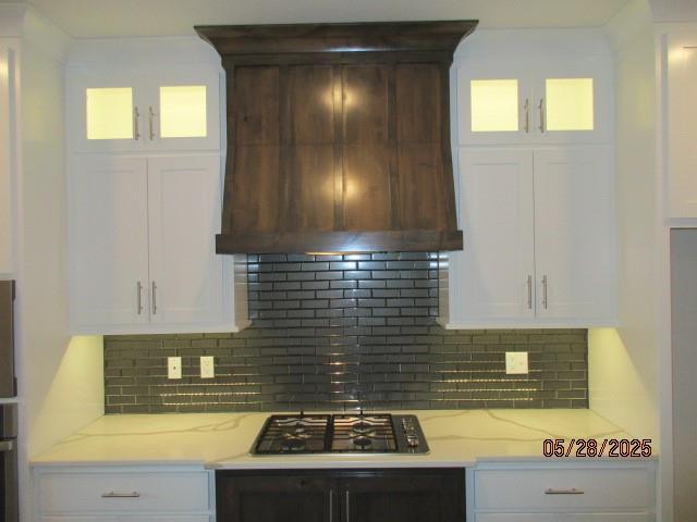 7031 N London Ave, Kansas City, MO 64151 - kitchen featuring premium range hood, stainless steel appliances, glass insert cabinets, and decorative backsplash