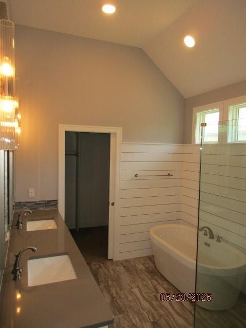 7031 N London Ave, Kansas City, MO 64151 - full bath featuring a soaking tub, double vanity, vaulted ceiling, and recessed lighting