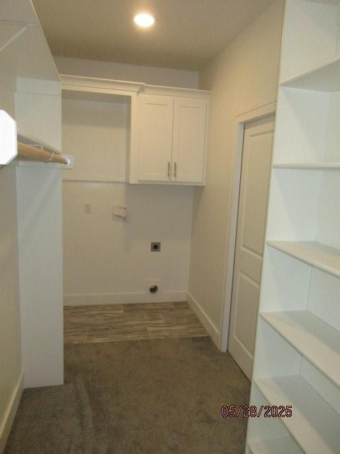 7031 N London Ave, Kansas City, MO 64151 - laundry room featuring electric dryer hookup, recessed lighting, carpet floors, baseboards, and cabinet space