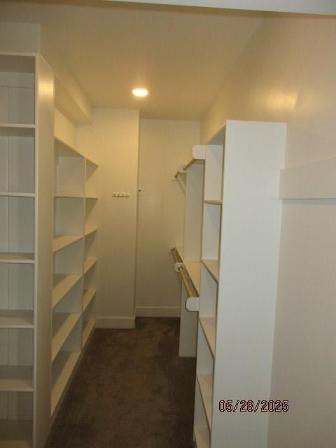 7031 N London Ave, Kansas City, MO 64151 - walk in closet featuring dark carpet