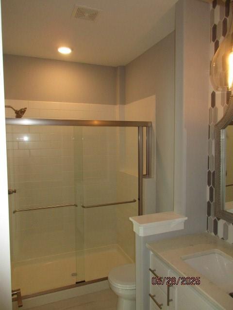 7031 N London Ave, Kansas City, MO 64151 - bathroom featuring a stall shower, vanity, and toilet