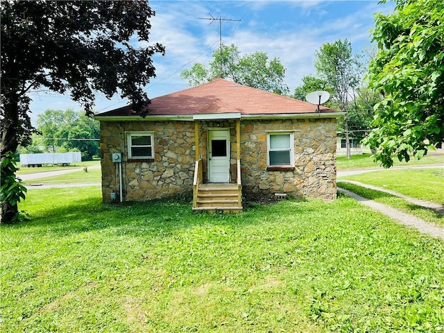 211 W 22nd St, Higginsville, MO 64037 - rear view of property with stone siding and a yard
