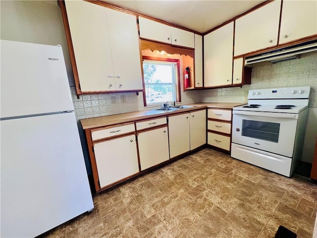 211 W 22nd St, Higginsville, MO 64037 - kitchen with white appliances, a sink, tasteful backsplash, stone finish flooring, and light countertops