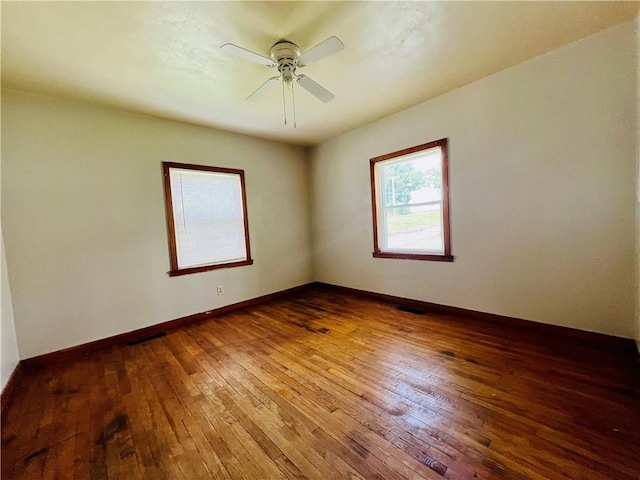 211 W 22nd St, Higginsville, MO 64037 - empty room featuring hardwood / wood-style flooring, a ceiling fan, and baseboards