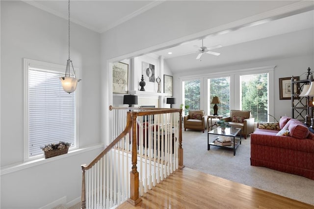 11518 W 143rd Ter, Olathe, KS 66062 - living room with a ceiling fan, light colored carpet, crown molding, a fireplace, and light wood-style floors