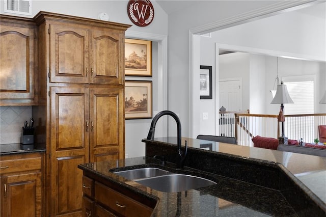 11518 W 143rd Ter, Olathe, KS 66062 - kitchen with dark stone countertops, backsplash, and vaulted ceiling