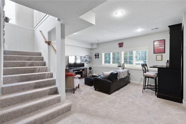 11518 W 143rd Ter, Olathe, KS 66062 - living area featuring light colored carpet, stairs, a textured ceiling, and recessed lighting