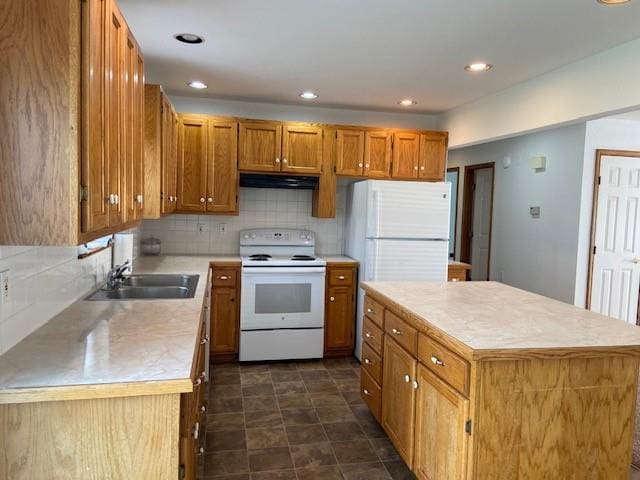 502A 3rd St, Plattsburg, MO 64477 - kitchen with electric range, under cabinet range hood, a sink, a kitchen island, and light countertops