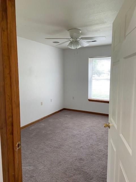 502A 3rd St, Plattsburg, MO 64477 - unfurnished room with carpet flooring, ceiling fan, and baseboards