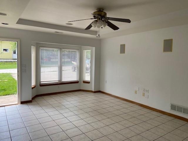 502A 3rd St, Plattsburg, MO 64477 - spare room with a tray ceiling, healthy amount of natural light, a ceiling fan, and baseboards