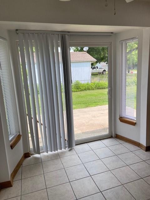 502A 3rd St, Plattsburg, MO 64477 - entryway featuring light tile patterned floors, baseboards, and ceiling fan