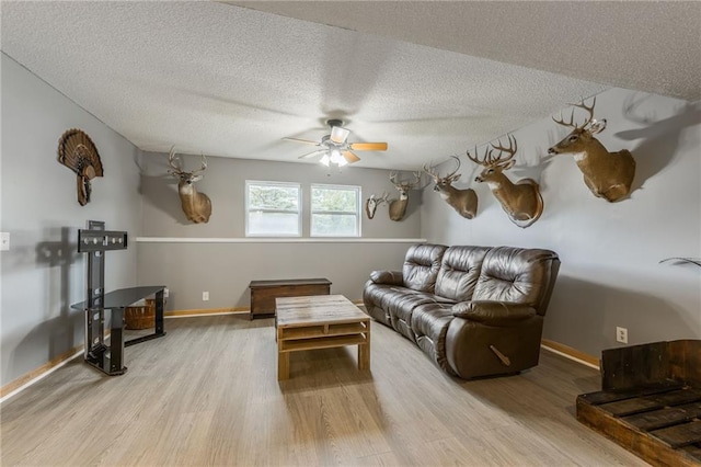 5488 SW Reed Ln, Trimble, MO 64492 - living area featuring light wood-style floors, ceiling fan, and a textured ceiling