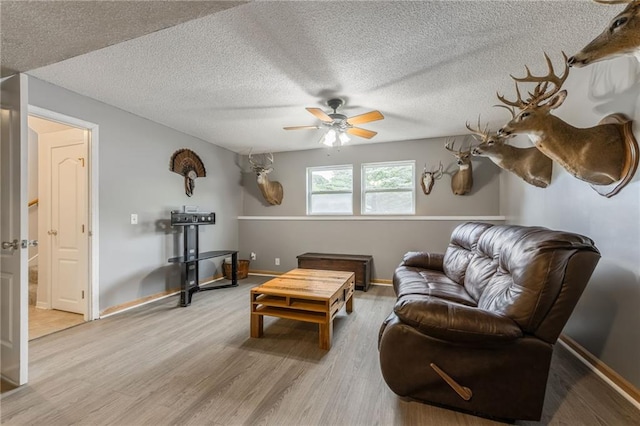 5488 SW Reed Ln, Trimble, MO 64492 - living room with a ceiling fan, light wood-style flooring, and a textured ceiling