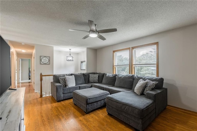 5488 SW Reed Ln, Trimble, MO 64492 - living room with a textured ceiling, light wood-type flooring, and a ceiling fan