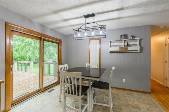 5488 SW Reed Ln, Trimble, MO 64492 - dining space with baseboards and a textured ceiling