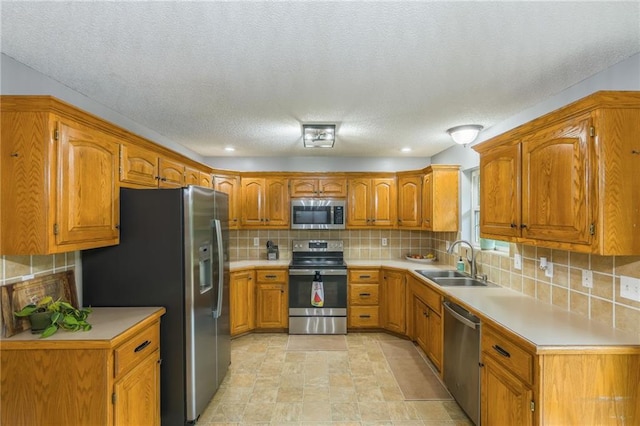 5488 SW Reed Ln, Trimble, MO 64492 - kitchen featuring stainless steel appliances, brown cabinets, light countertops, and a textured ceiling