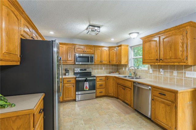 5488 SW Reed Ln, Trimble, MO 64492 - kitchen with stainless steel appliances, brown cabinetry, decorative backsplash, light countertops, and a textured ceiling