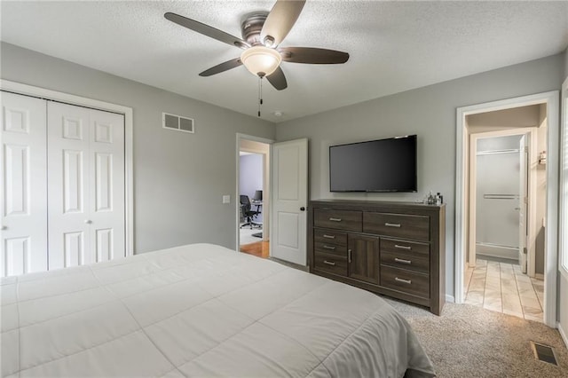 5488 SW Reed Ln, Trimble, MO 64492 - bedroom with light carpet, a closet, a textured ceiling, and a ceiling fan