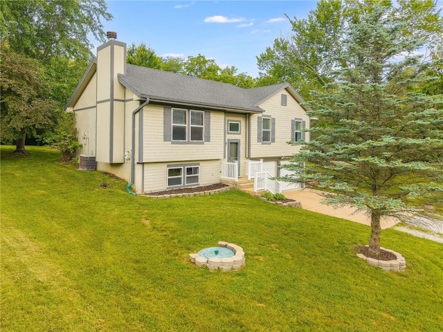 5488 SW Reed Ln, Trimble, MO 64492 - split foyer home featuring a chimney, a front lawn, and an attached garage