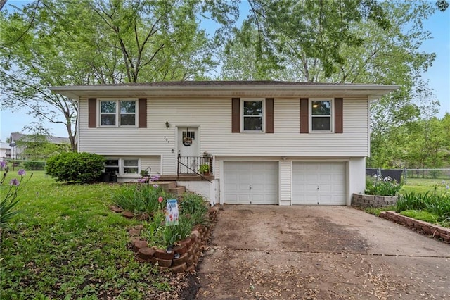 504 W 5th Ct, Peculiar, MO 64078 - split foyer home featuring an attached garage and concrete driveway