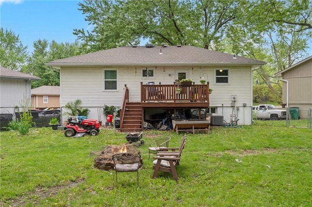 504 W 5th Ct, Peculiar, MO 64078 - rear view of property with an outdoor fire pit, a wooden deck, stairway, and central AC