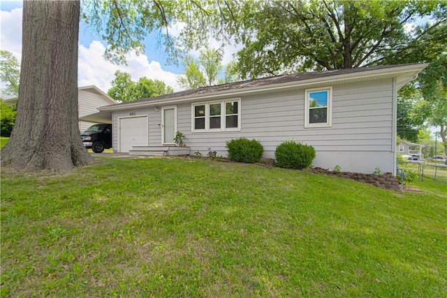 4511 NE 45th St, Kansas City, MO 64117 - view of front facade with a garage and a front lawn