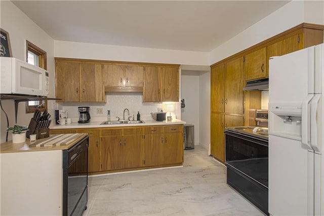 4511 NE 45th St, Kansas City, MO 64117 - kitchen featuring black appliances, under cabinet range hood, light countertops, light marble finish flooring, and brown cabinetry
