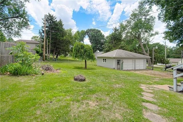 4511 NE 45th St, Kansas City, MO 64117 - view of yard with a garage, an outdoor fire pit, and an outdoor structure