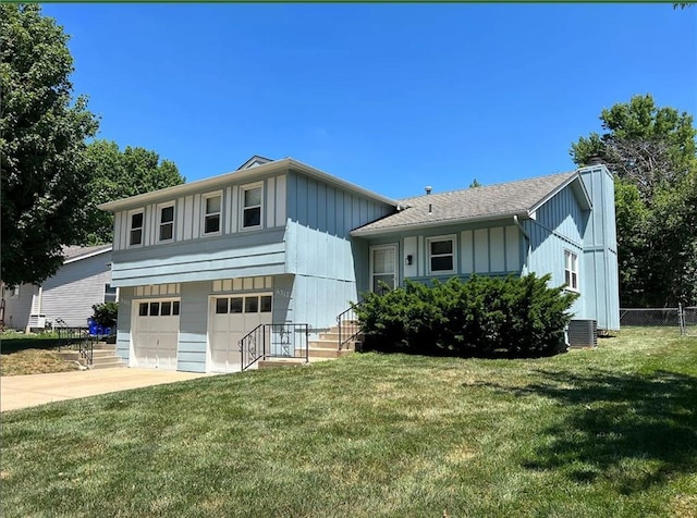 6315 Hallet St, Shawnee, KS 66216 - split level home featuring board and batten siding, an attached garage, driveway, and a chimney