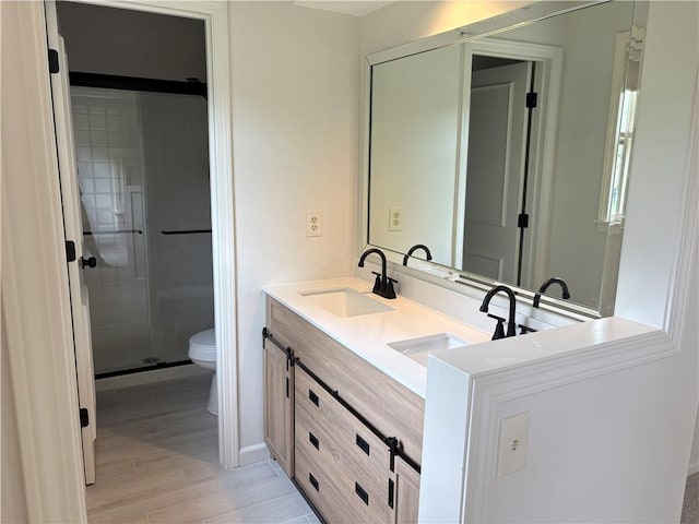3647 NW Blue Jacket Dr, Lees Summit, MO 64064 - bathroom featuring wood finished floors, double vanity, and a shower stall