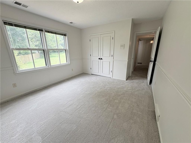 3647 NW Blue Jacket Dr, Lees Summit, MO 64064 - unfurnished bedroom with light colored carpet, a textured ceiling, and a closet