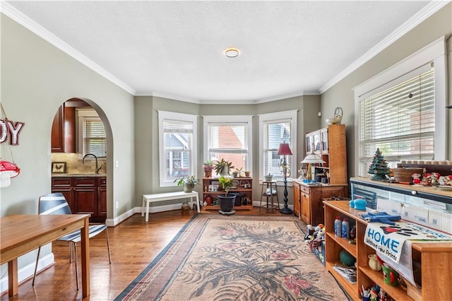 808 N River Blvd, Independence, MO 64050 - sitting room featuring light wood-type flooring, crown molding, arched walkways, and baseboards