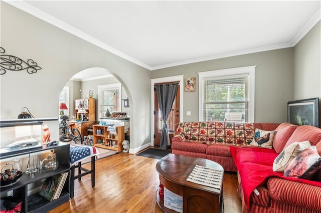 808 N River Blvd, Independence, MO 64050 - living area with plenty of natural light, crown molding, wood finished floors, arched walkways, and baseboards