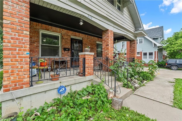 808 N River Blvd, Independence, MO 64050 - view of exterior entry with covered porch and brick siding