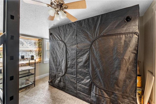 808 N River Blvd, Independence, MO 64050 - carpeted bedroom featuring a textured ceiling, baseboards, and ceiling fan