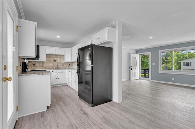 7314 NW 84th Ter, Kansas City, MO 64153 - kitchen featuring freestanding refrigerator, light wood-type flooring, range, white cabinets, and recessed lighting