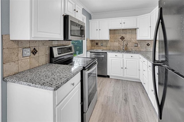7314 NW 84th Ter, Kansas City, MO 64153 - kitchen with stainless steel appliances, a sink, white cabinetry, light wood finished floors, and ornamental molding