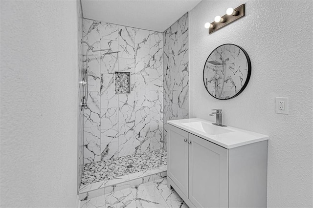 7314 NW 84th Ter, Kansas City, MO 64153 - full bathroom featuring vanity, marble look tiles, a textured wall, and a marble finish shower