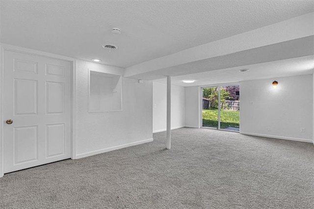 7314 NW 84th Ter, Kansas City, MO 64153 - below grade area featuring a textured ceiling, carpet flooring, and baseboards