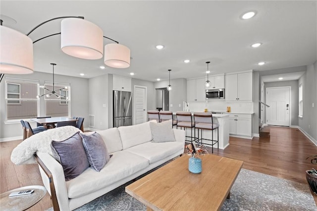 8810 SW 9th Ter, Blue Springs, MO 64064 - living area with wood finished floors, recessed lighting, and a chandelier