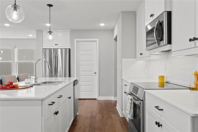 8810 SW 9th Ter, Blue Springs, MO 64064 - kitchen with appliances with stainless steel finishes, dark wood finished floors, decorative backsplash, white cabinetry, and recessed lighting