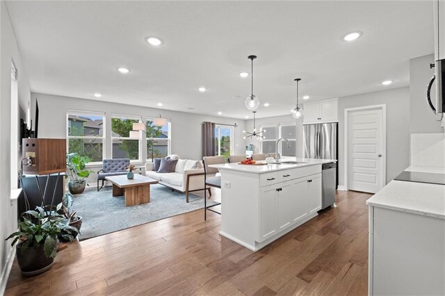 8810 SW 9th Ter, Blue Springs, MO 64064 - kitchen featuring open floor plan, appliances with stainless steel finishes, recessed lighting, wood finished floors, and white cabinetry