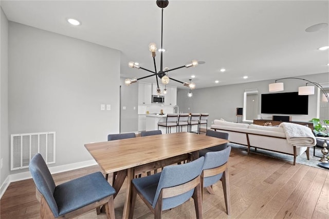 8810 SW 9th Ter, Blue Springs, MO 64064 - dining area with wood finished floors, recessed lighting, and a chandelier